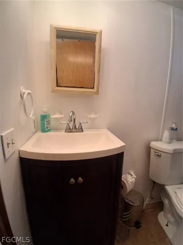 a view of a house with a yard balcony and wooden fence