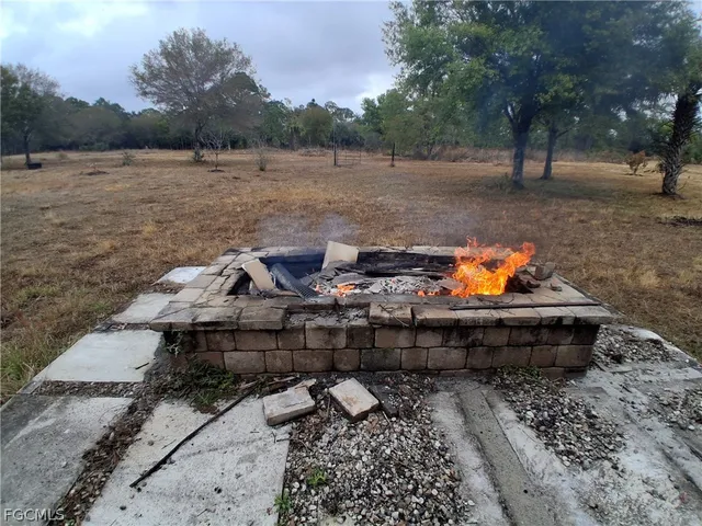 a backyard of a house with table and chairs