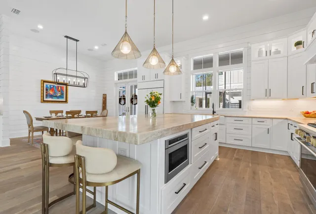 a dining room with furniture a rug and wooden floor