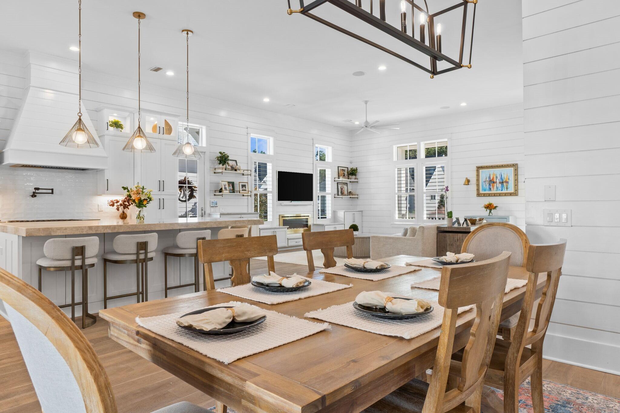 92 Rosecourt Street Inlet Beach, FL 32461 - Photo 13 of 65 a dining room with furniture a rug and wooden floor