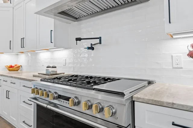 a kitchen with sink cabinets and stove