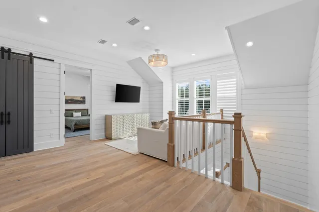 a bedroom with furniture and a flat screen tv