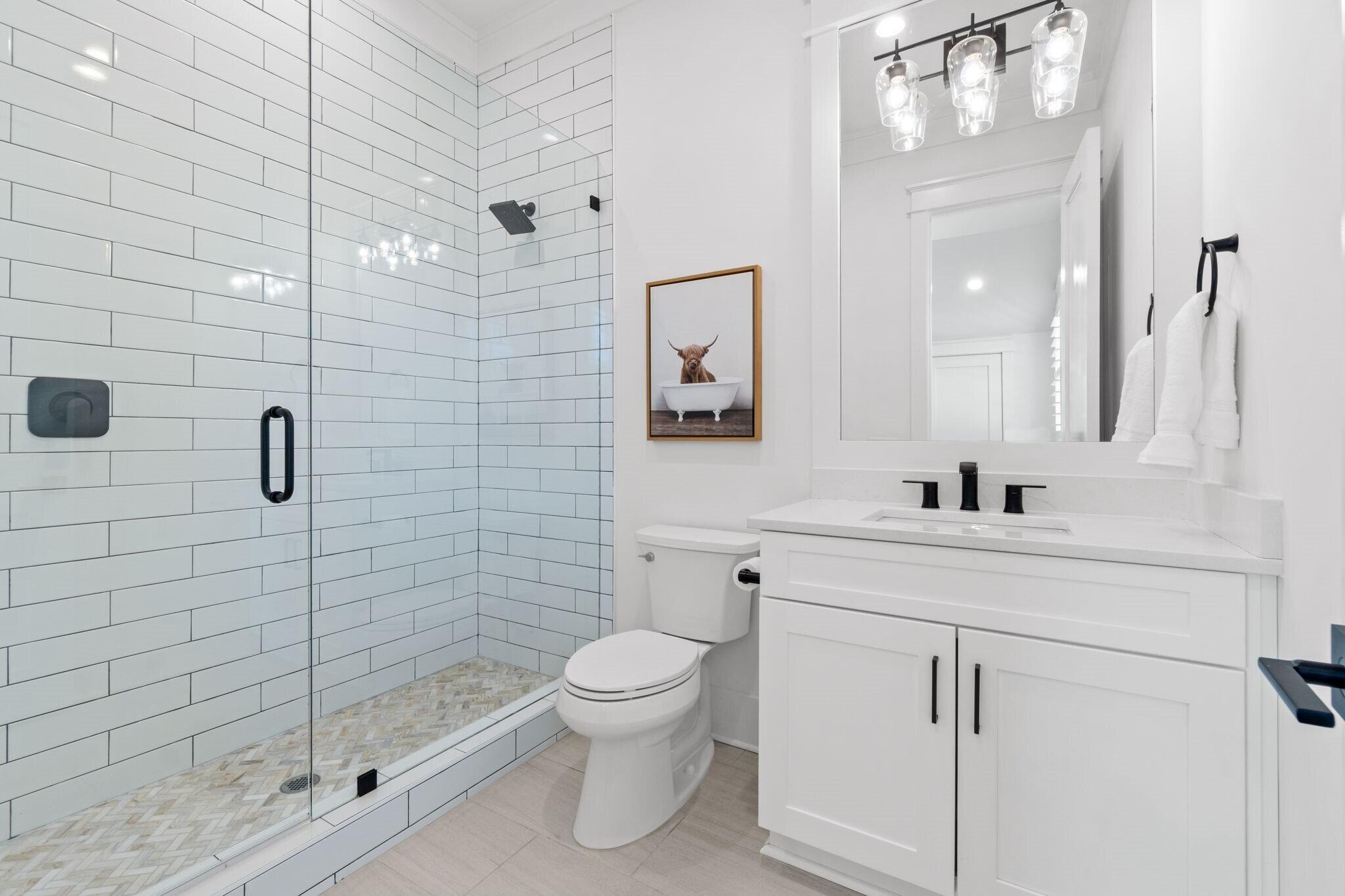 92 Rosecourt Street Inlet Beach, FL 32461 - Photo 34 of 65 a bathroom with a toilet sink vanity and mirror