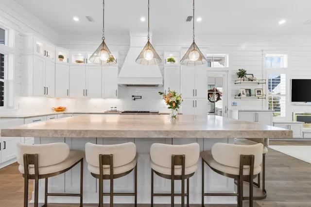 a kitchen with cabinets and chairs