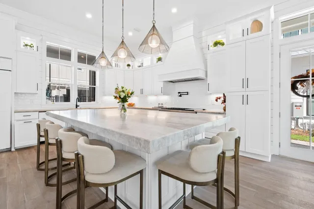 a kitchen with kitchen island a table and chairs in it