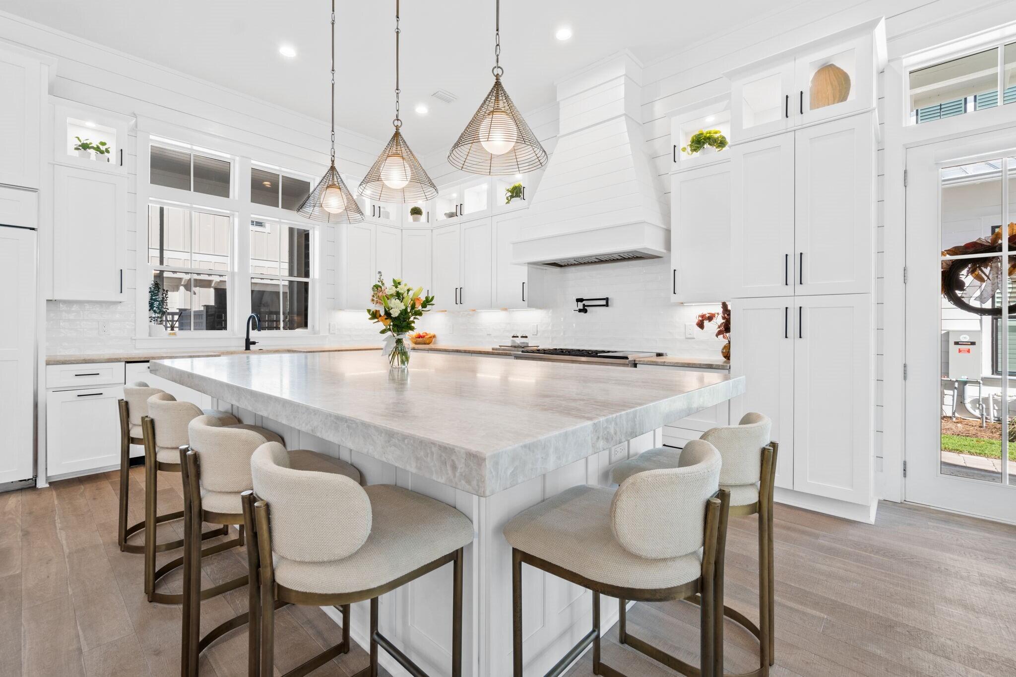 92 Rosecourt Street Inlet Beach, FL 32461 - Photo 10 of 65 a kitchen with kitchen island a table and chairs in it