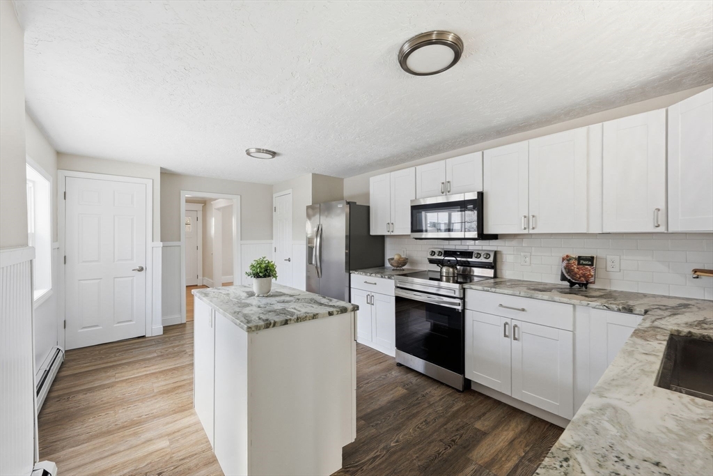 2 Cycle Street Westfield, MA 01085 - Photo 8 of 30 a kitchen with granite countertop a stove top oven sink and cabinets