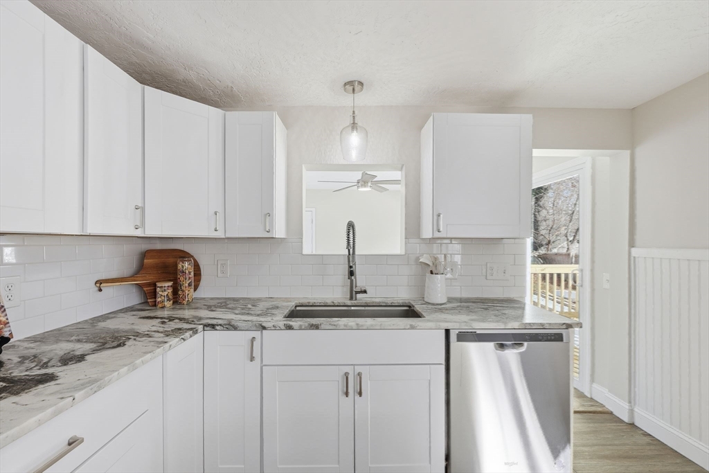 2 Cycle Street Westfield, MA 01085 - Photo 9 of 30 a kitchen with granite countertop a sink a stove and cabinets