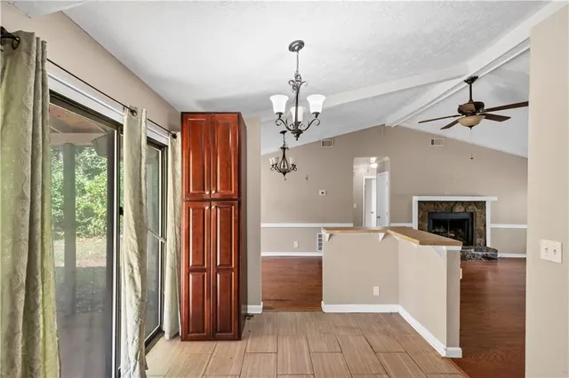 a view of a kitchen with a sink oven cabinet and windows