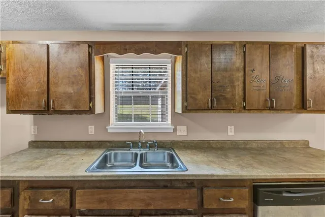 a kitchen with a sink and a window