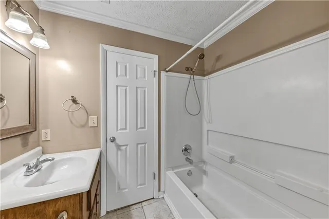 a bathroom with a tub a sink and a mirror