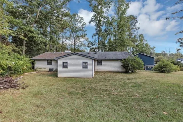 a white house that has a tree in front of it