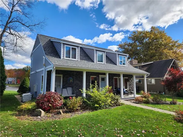 a front view of a house with garden and porch