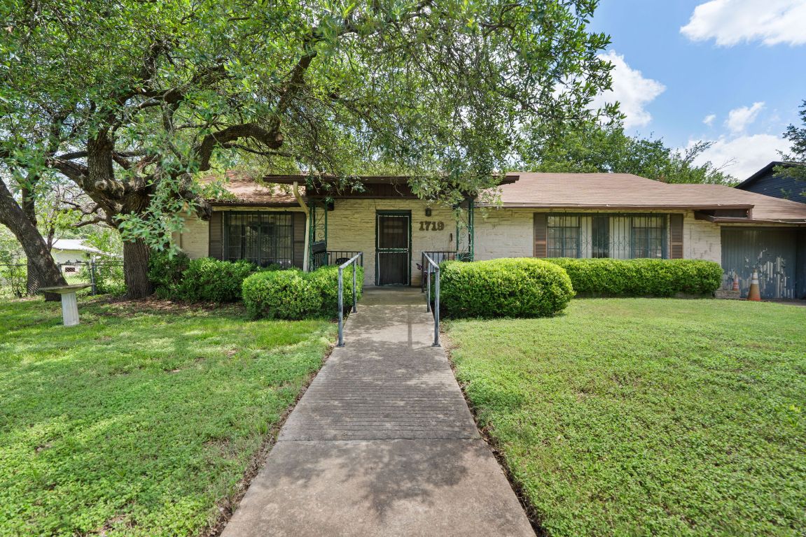 1719 East 32nd Street Austin, TX 78722 - Photo 3 of 13 a front view of a house with a garden