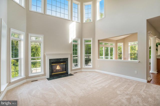 a view of a livingroom with a fireplace and window