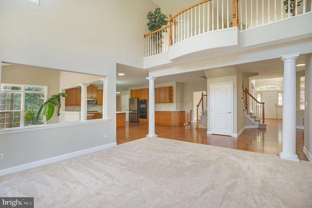 a view of a hallway with wooden floor and a large window