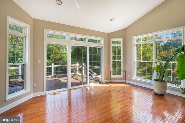 a view of a room with wooden floor and windows