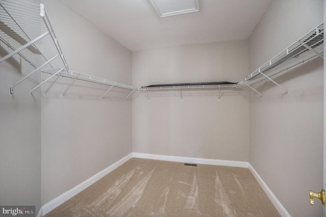 a spacious bedroom with a large bed and windows