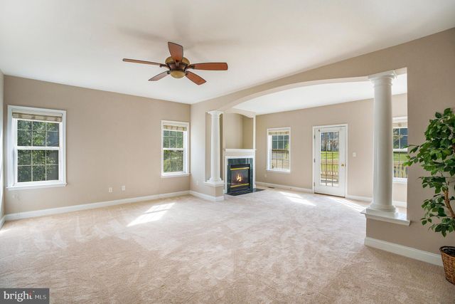 a view of a livingroom with a ceiling fan and window