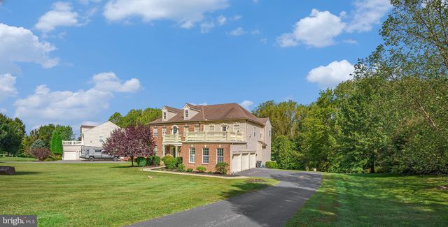 a view of a big building with a big yard and large trees
