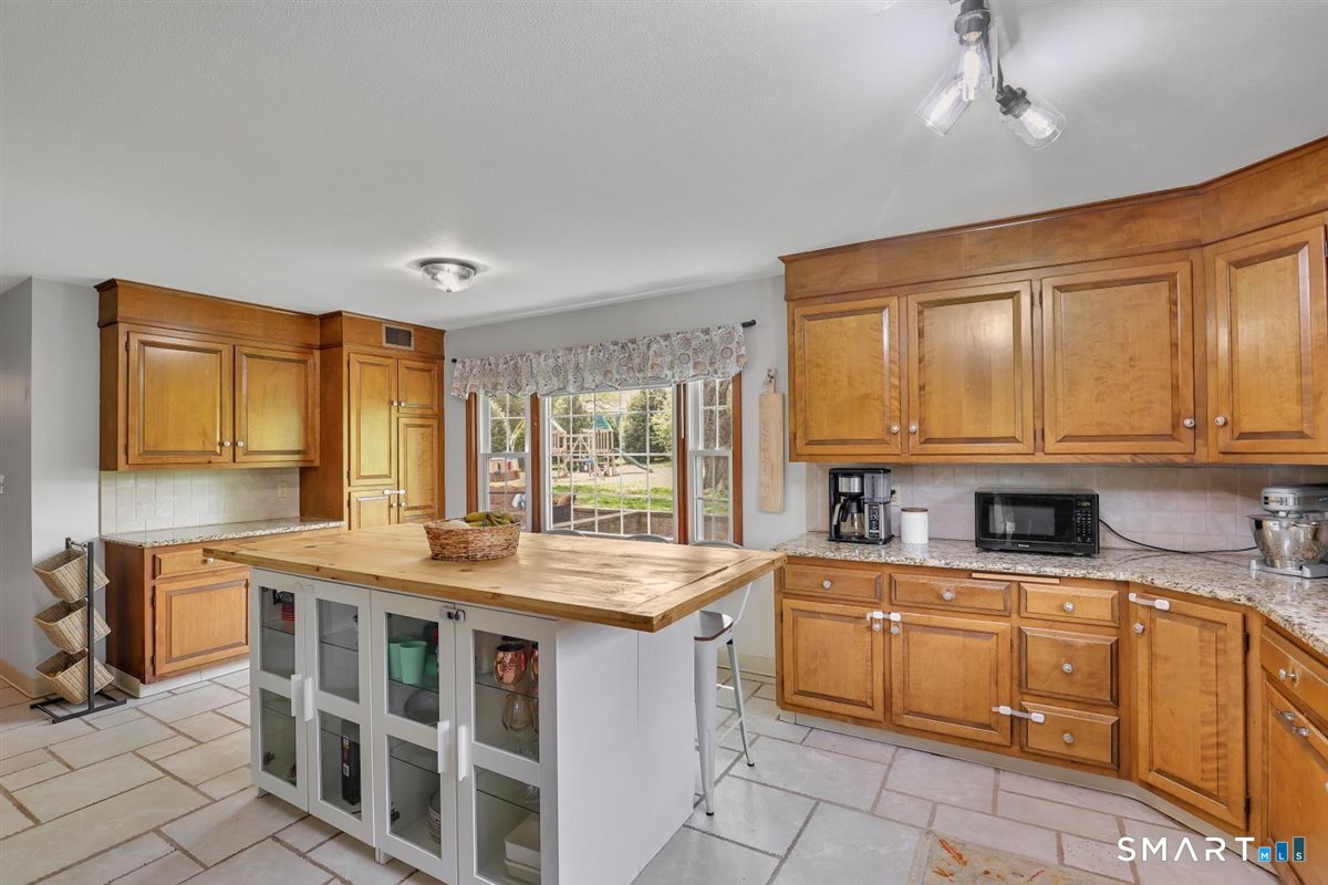 72 Old Post Road Wethersfield, CT 06109 - Photo 9 of 40 a kitchen with a sink stove and cabinets