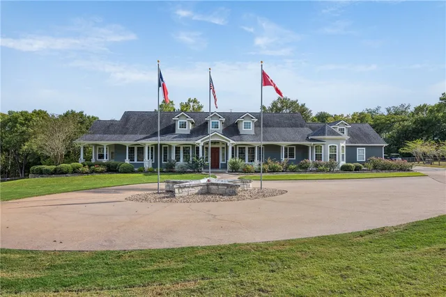 a front view of a house with swimming pool and porch