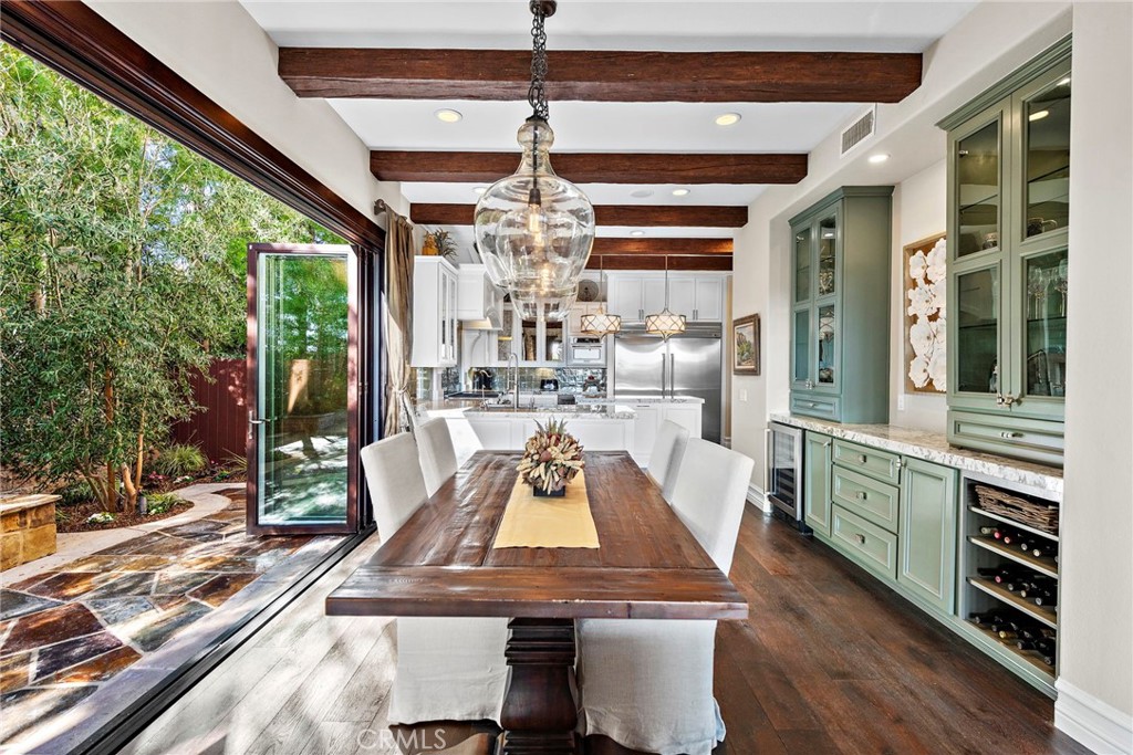 18651 Topanga Canyon Road Silverado, CA 92676 - Photo 15 of 55 a view of a dining room with furniture a chandelier and large windows