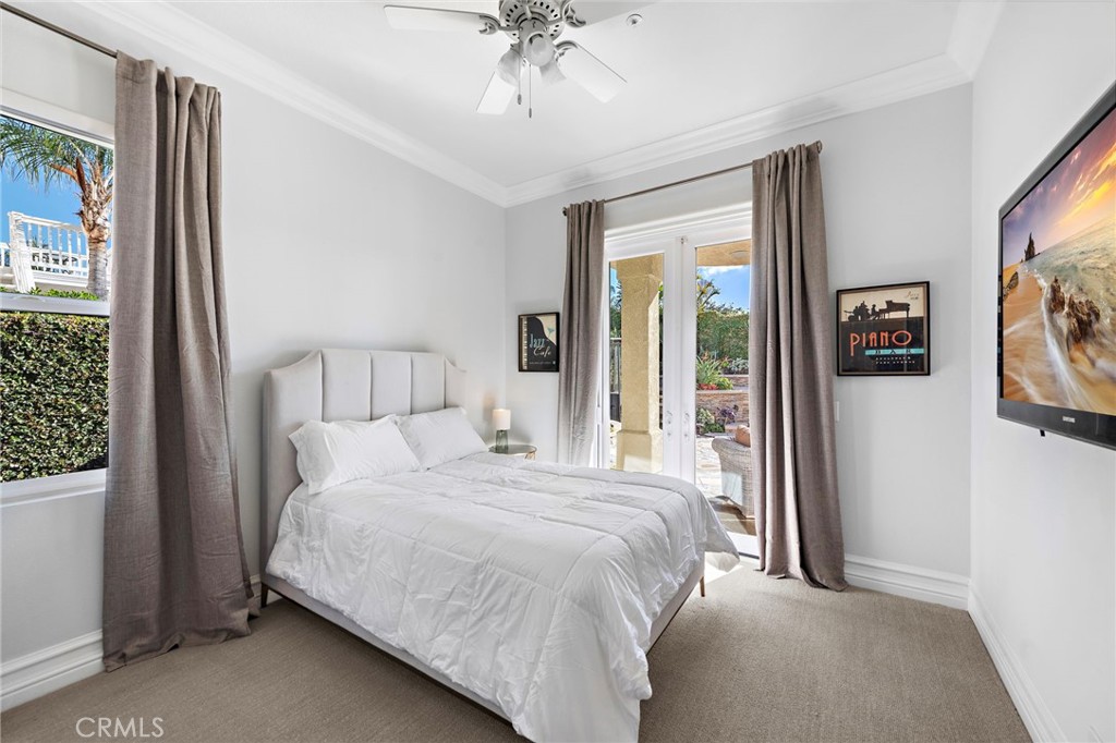 18651 Topanga Canyon Road Silverado, CA 92676 - Photo 22 of 55 a bedroom with a bed and a chandelier