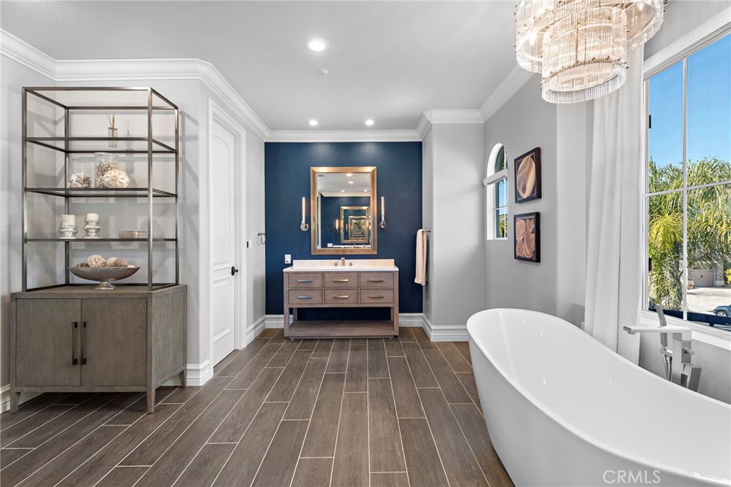 18651 Topanga Canyon Road Silverado, CA 92676 - Photo 29 of 55 a spacious bedroom with a bed and a chandelier