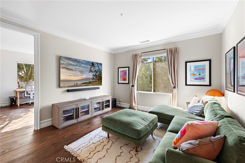 18651 Topanga Canyon Road Silverado, CA 92676 - Photo 38 of 55 a living room with furniture and a flat screen tv with wooden floor