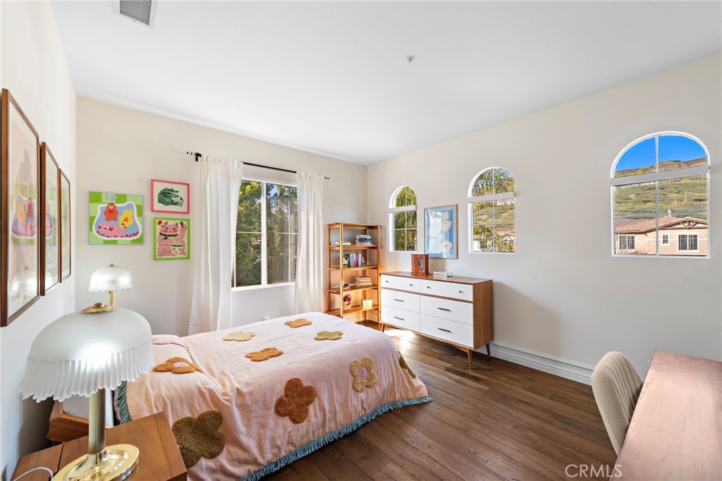 18651 Topanga Canyon Road Silverado, CA 92676 - Photo 40 of 55 a bedroom with a bed and wooden floor