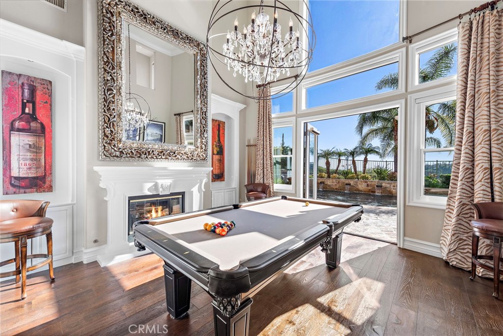 18651 Topanga Canyon Road Silverado, CA 92676 - Photo 6 of 55 a room with chandelier and wooden floor