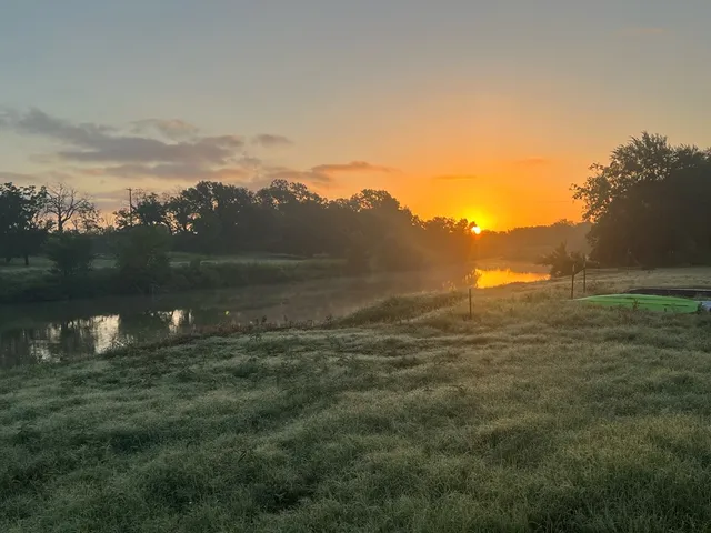 a view of a lake in a field