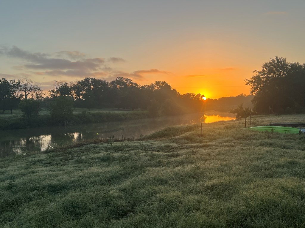 385 Ranch Road 1 Stonewall, TX 78671 - Photo 2 of 20 a view of a lake in a field