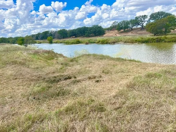 a view of a lake with houses in the back