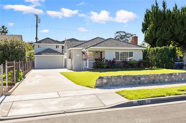 a view of a house with a swimming pool and a yard