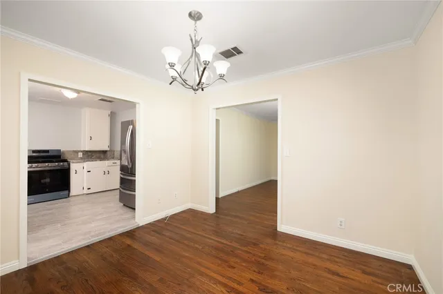 a view of a kitchen with a sink and wooden floor
