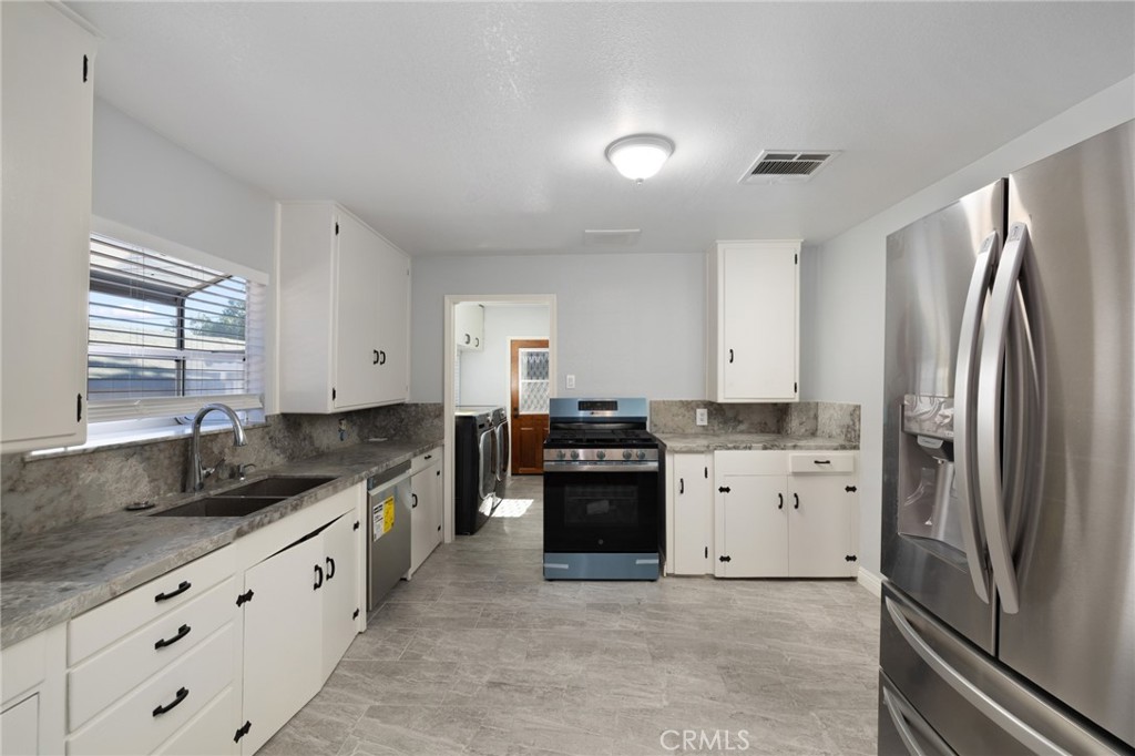 3920 Elma Road Pasadena, CA 91107 - Photo 14 of 29 a large kitchen with cabinets a sink and stainless steel appliances
