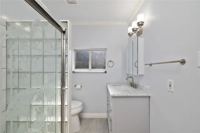 a bathroom with a toilet sink and shower