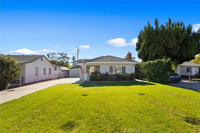 a front view of a house with yard and swimming pool