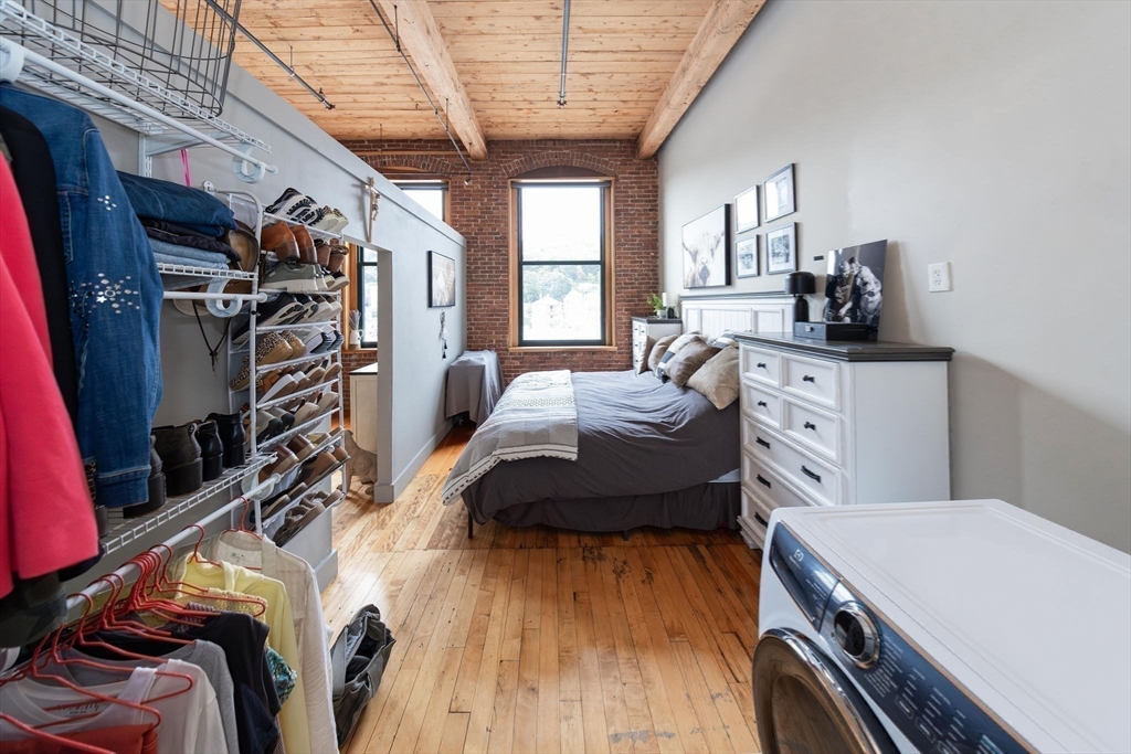 1 Envelope Terrace, Unit 302 Worcester, MA 01604 - Photo 22 of 42 a bedroom with a bed and a book shelf