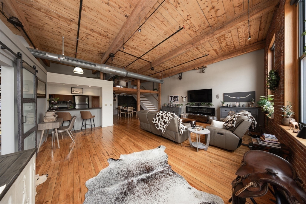 1 Envelope Terrace, Unit 302 Worcester, MA 01604 - Photo 31 of 42 a living room with furniture kitchen view and a flat screen tv