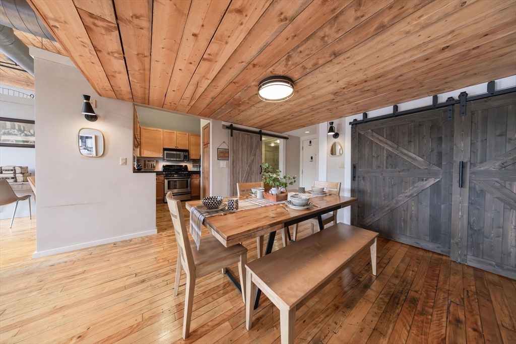 1 Envelope Terrace, Unit 302 Worcester, MA 01604 - Photo 4 of 42 a view of a dining room with furniture and wooden floor