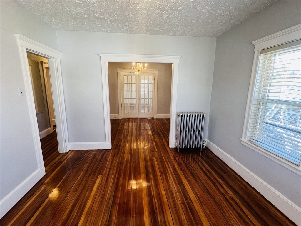 62 Westmore Road, Unit 2 Boston, MA 02126 - Photo 7 of 13 a view of wooden floor in a room