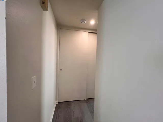 a view of hallway with wooden floor