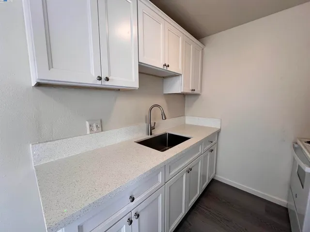 a kitchen with stainless steel appliances granite countertop a sink and cabinets