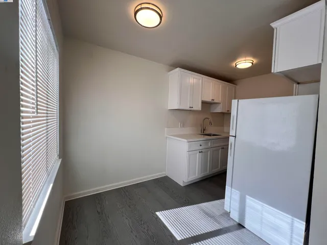 a kitchen with a refrigerator sink and stove
