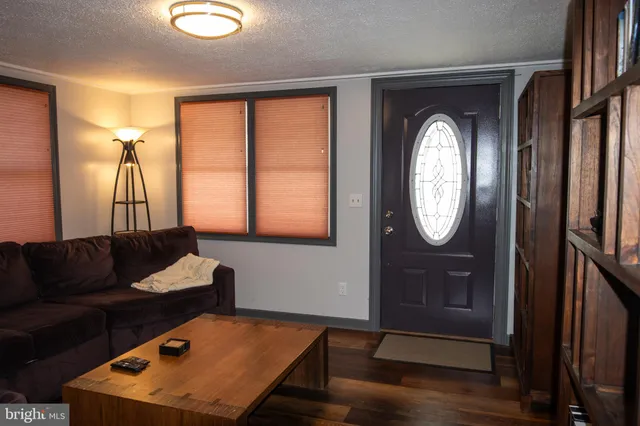 a view of a workspace with furniture and wooden floor