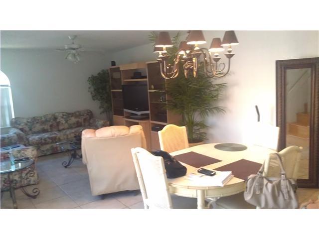 8242 Severn Drive, Unit A Boca Raton, FL 33433 - Photo 3 of 11 a balcony with table and chairs