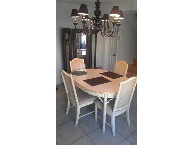 8242 Severn Drive, Unit A Boca Raton, FL 33433 - Photo 4 of 11 a dining room with furniture and chandelier